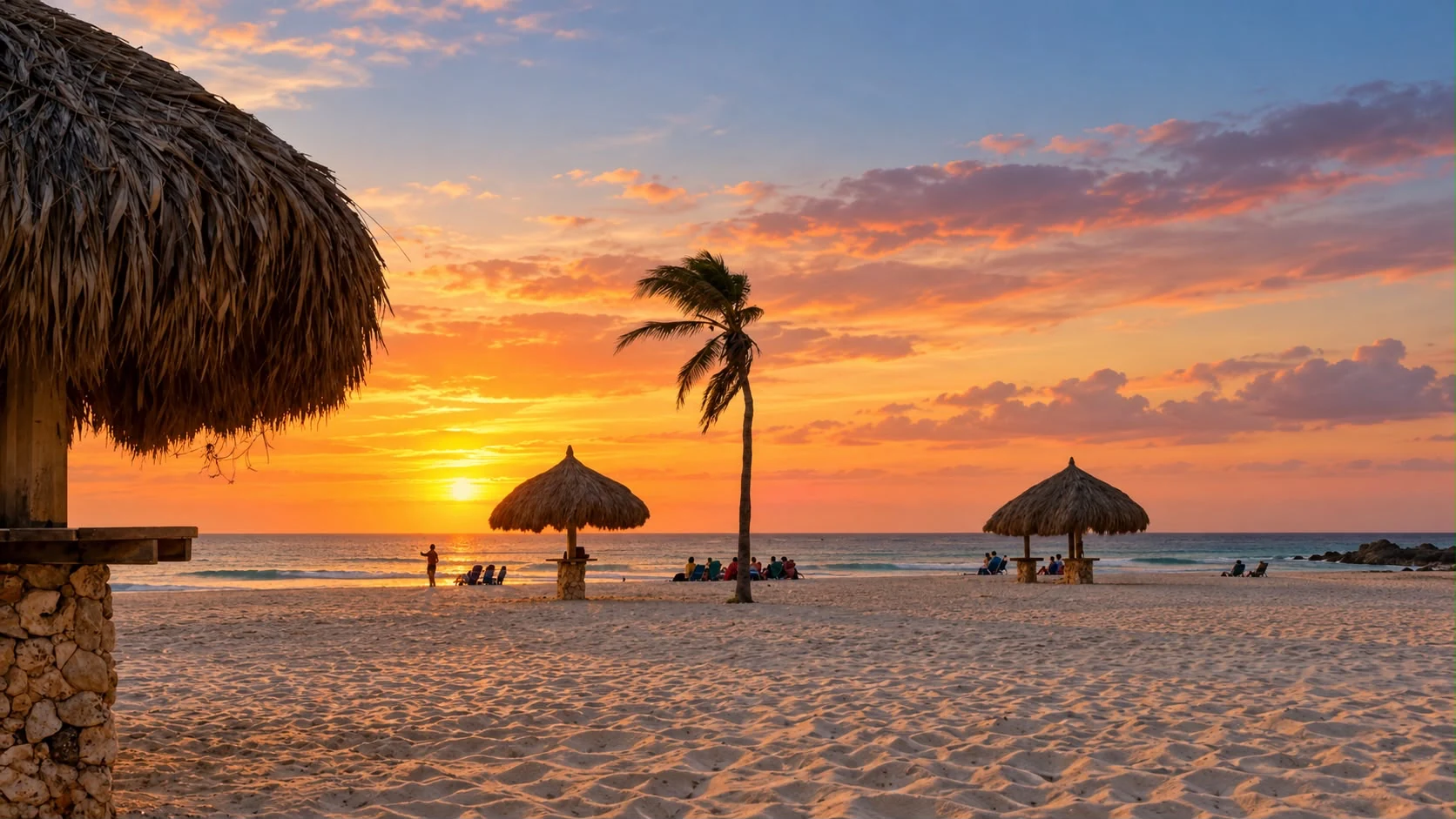 Golden sunset over Arashi Beach, with a palm tree and thatched palapas on the sand