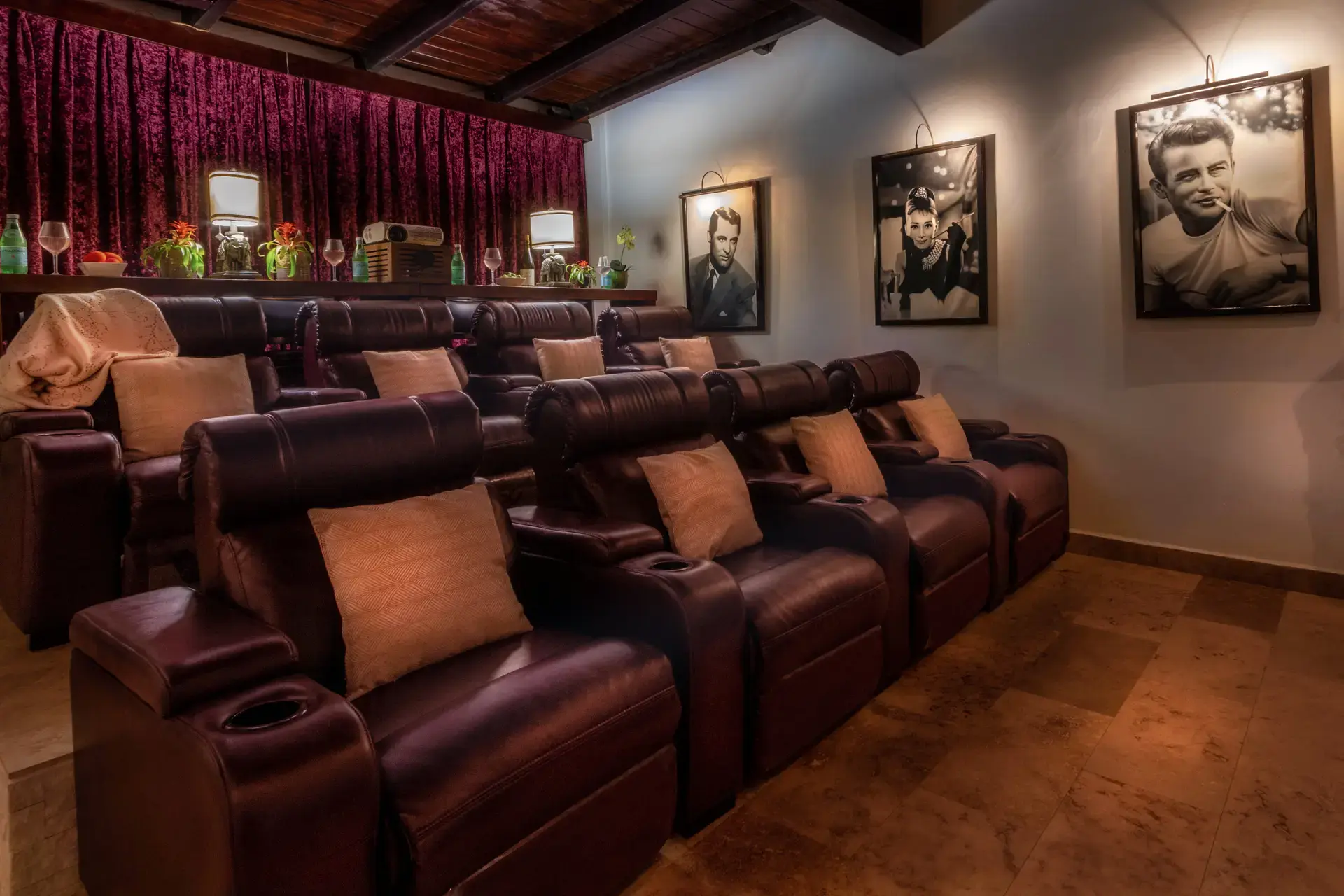 Leather recliners, warm lamps, and Hollywood-inspired portraits in The Bali Cinema