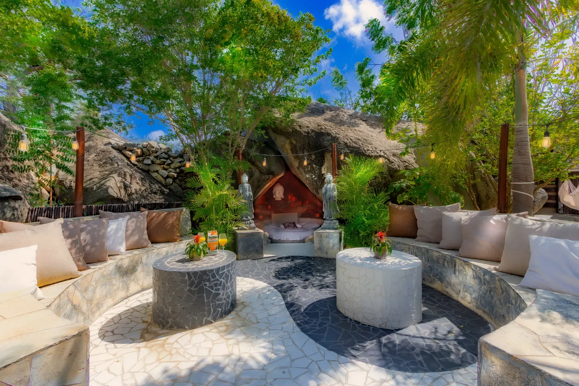 Seating in the Zen Circle facing the Buddha Cave in Bali Retreat Aruba’s tropical garden